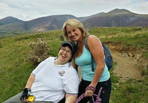 Michelle volunteering as a buddy and smiling with a participant